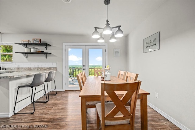 1003 Blair St, Pocola, OK 74902 - dining space with dark wood finished floors, french doors, a chandelier, and baseboards