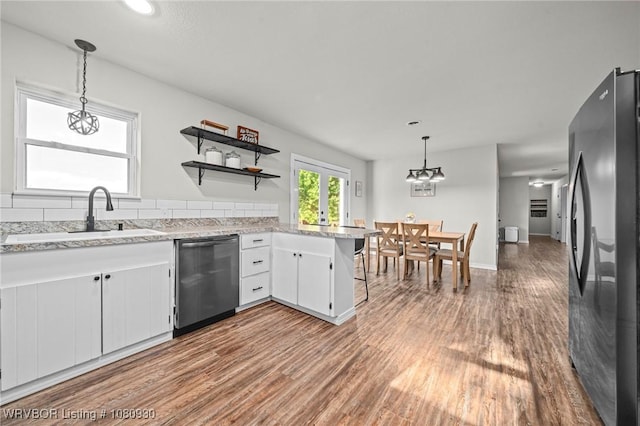 1003 Blair St, Pocola, OK 74902 - kitchen with appliances with stainless steel finishes, a sink, wood finished floors, and white cabinets