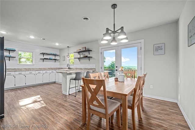 1003 Blair St, Pocola, OK 74902 - dining room featuring wood finished floors, a chandelier, baseboards, french doors, and recessed lighting