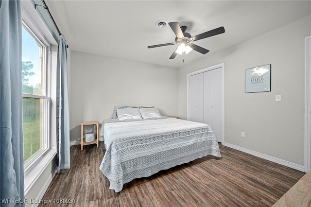 1003 Blair St, Pocola, OK 74902 - bedroom with baseboards, dark wood-type flooring, a closet, and ceiling fan