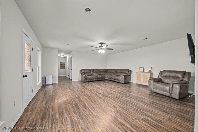 1003 Blair St, Pocola, OK 74902 - living area featuring dark wood finished floors, a ceiling fan, and baseboards