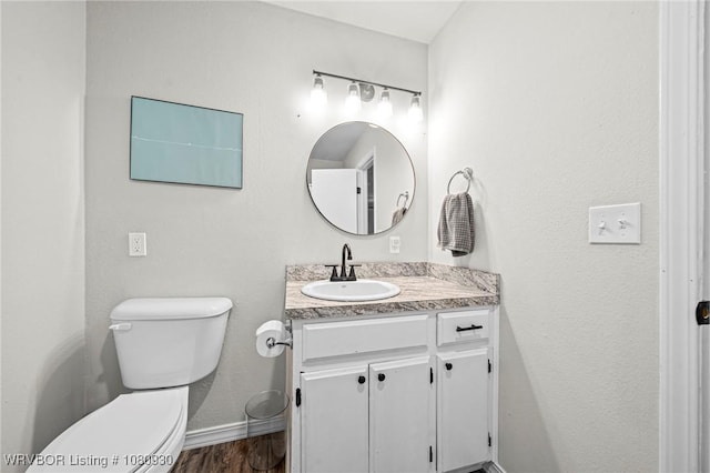 1003 Blair St, Pocola, OK 74902 - bathroom with toilet, vanity, baseboards, and wood finished floors