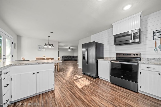 1003 Blair St, Pocola, OK 74902 - kitchen with appliances with stainless steel finishes, dark wood-type flooring, and white cabinetry