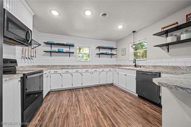 1003 Blair St, Pocola, OK 74902 - kitchen with open shelves, black range with electric stovetop, dishwashing machine, stainless steel microwave, and a sink
