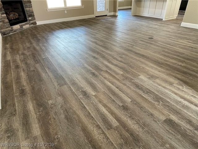 details with a fireplace and wood-type flooring