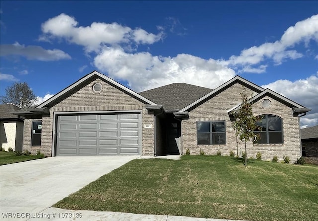 view of front facade with a front yard and a garage