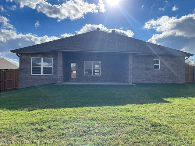 rear view of property with a patio area and a yard