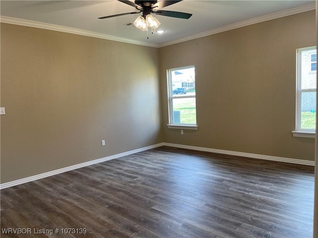 spare room with a wealth of natural light, ceiling fan, dark wood-type flooring, and ornamental molding