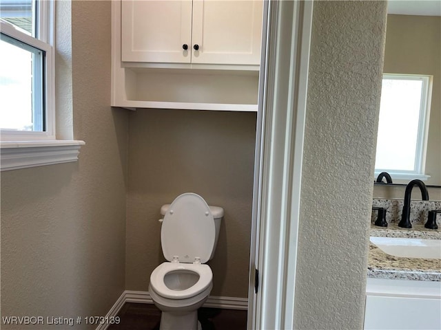 bathroom featuring vanity and toilet