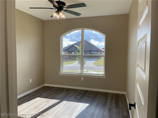 spare room with dark hardwood / wood-style floors and ceiling fan