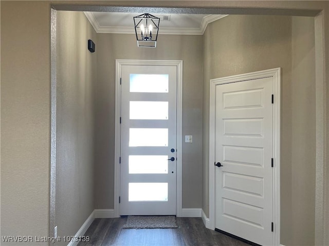 entrance foyer featuring crown molding, dark hardwood / wood-style floors, and an inviting chandelier