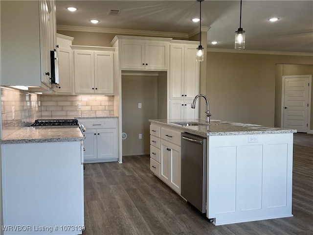 kitchen with a center island with sink, white cabinets, hanging light fixtures, and sink