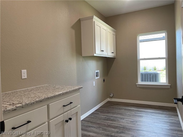 washroom with hookup for an electric dryer, washer hookup, dark hardwood / wood-style floors, and cabinets