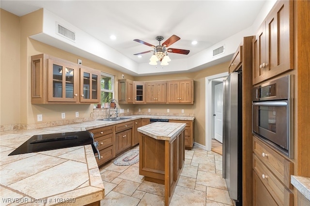 1760 N Ulmer St, Greenwood, AR 72936 - kitchen with appliances with stainless steel finishes, a sink, stone tile floors, ceiling fan, and tile countertops