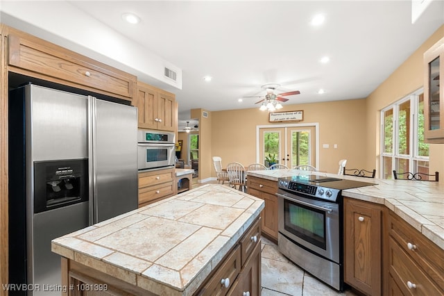 1760 N Ulmer St, Greenwood, AR 72936 - kitchen featuring stainless steel appliances, french doors, a peninsula, recessed lighting, and tile counters