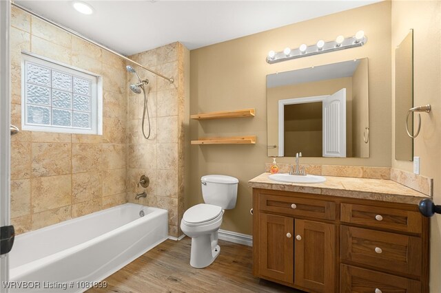 1760 N Ulmer St, Greenwood, AR 72936 - bathroom with toilet, vanity, shower / bath combination, wood finished floors, and baseboards