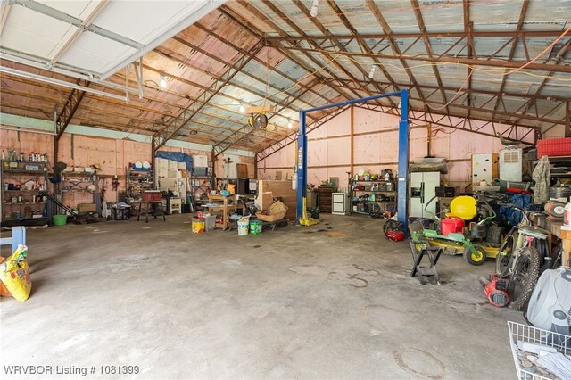 1760 N Ulmer St, Greenwood, AR 72936 - garage featuring a workshop area and white fridge with ice dispenser