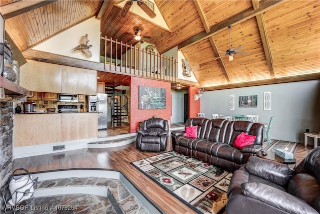 living area featuring stairs, wooden ceiling, wood finished floors, and beam ceiling