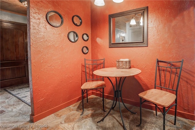 dining area with a textured wall and baseboards