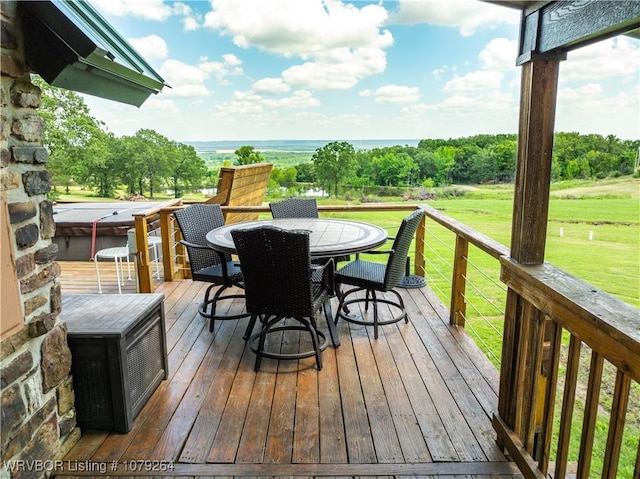 deck with a yard and outdoor dining space