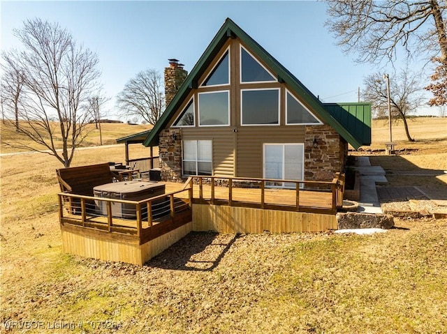 back of property featuring a chimney and a wooden deck