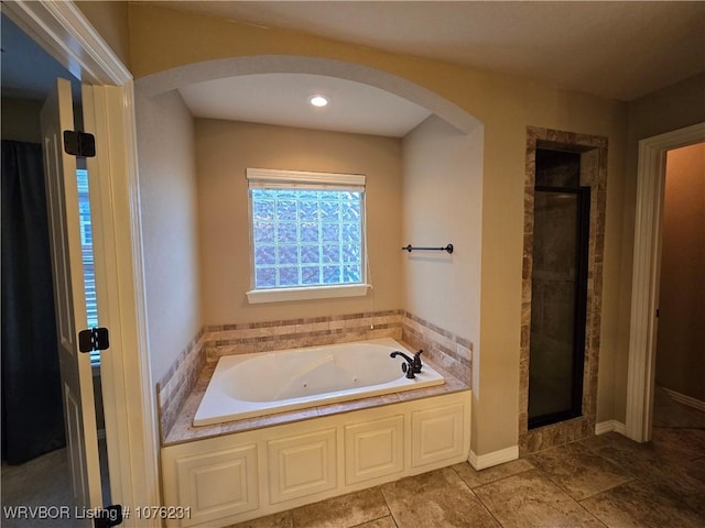 bathroom featuring tile patterned flooring and independent shower and bath