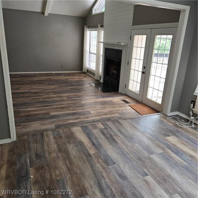 10704 Castleton St, Fort Smith, AR 72908 - unfurnished living room featuring french doors, wood finished floors, and a fireplace with flush hearth