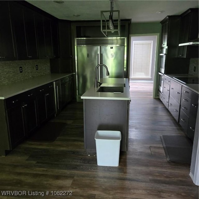 10704 Castleton St, Fort Smith, AR 72908 - kitchen with stainless steel appliances, dark wood-style flooring, backsplash, hanging light fixtures, and light countertops