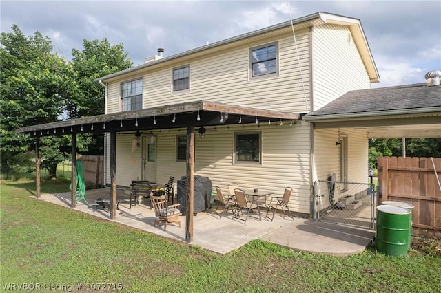 rear view of property with a lawn and a patio area