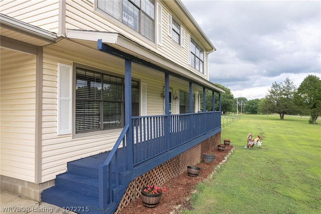 view of property exterior with covered porch and a lawn