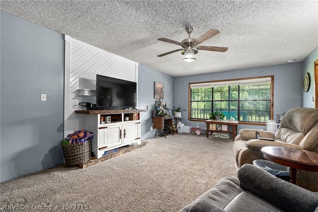 carpeted living room with ceiling fan and a textured ceiling