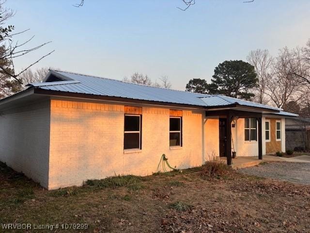 view of side of property featuring metal roof