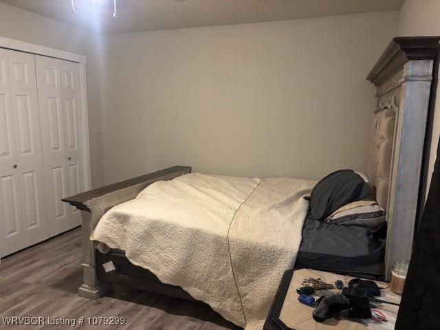 bedroom with a closet and wood finished floors