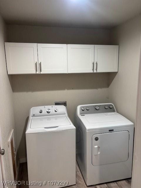 laundry area with cabinet space and separate washer and dryer