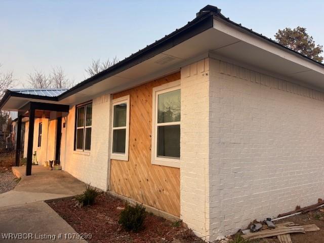 view of property exterior with metal roof