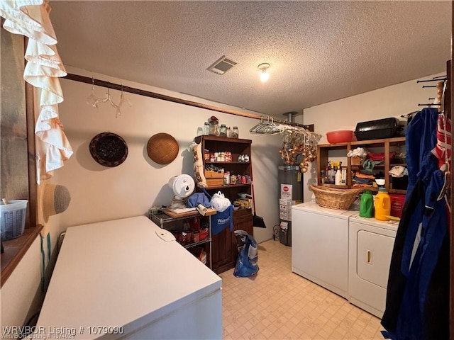 5525 Slaytonville Rd, Hackett, AR 72937 - clothes washing area with laundry area, visible vents, light floors, water heater, and separate washer and dryer