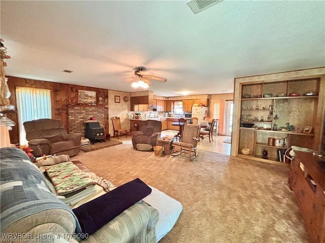 5525 Slaytonville Rd, Hackett, AR 72937 - living room featuring a wood stove, a textured ceiling, visible vents, and a wealth of natural light