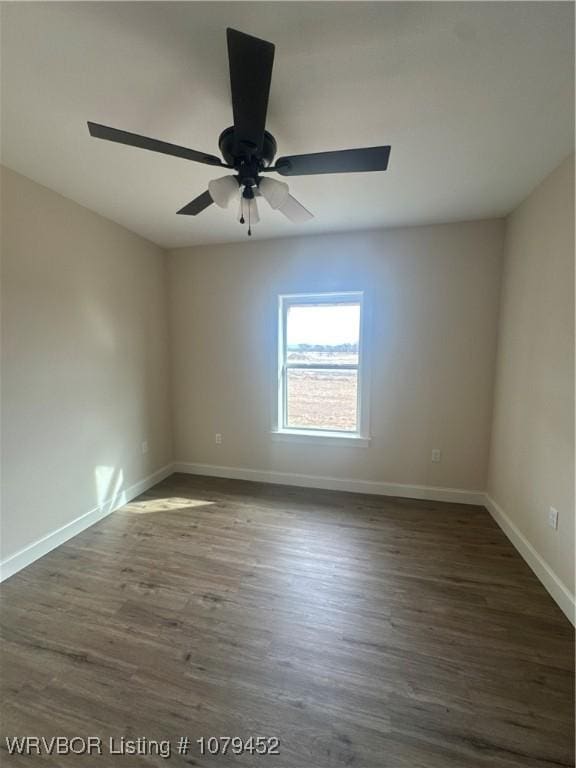 empty room with dark wood-type flooring, ceiling fan, and baseboards