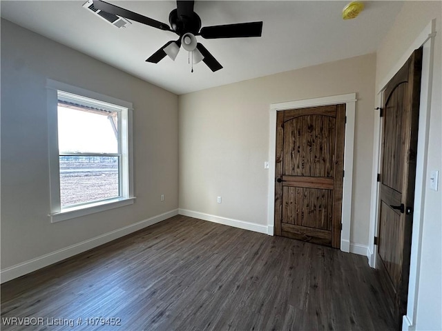 interior space with dark wood-style floors, visible vents, and baseboards