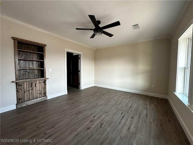 unfurnished room featuring dark wood-type flooring, visible vents, and crown molding