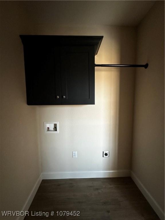 washroom with cabinet space, baseboards, dark wood finished floors, hookup for a washing machine, and hookup for an electric dryer