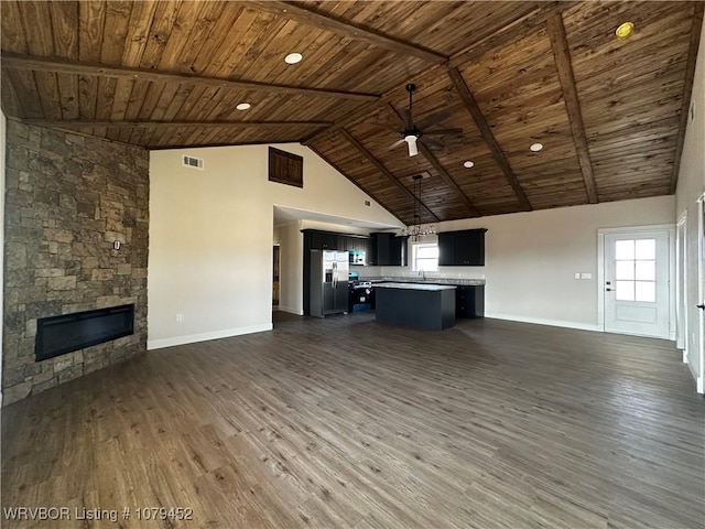 kitchen featuring dark wood-style flooring, a fireplace, visible vents, open floor plan, and appliances with stainless steel finishes