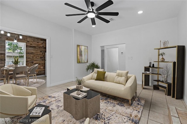 living area featuring light tile patterned floors, a ceiling fan, baseboards, and recessed lighting