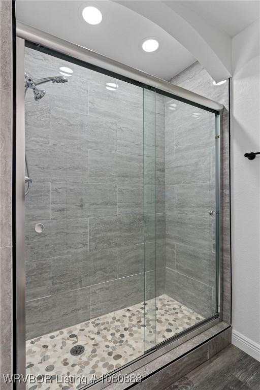 bathroom featuring a stall shower, recessed lighting, baseboards, and wood finished floors