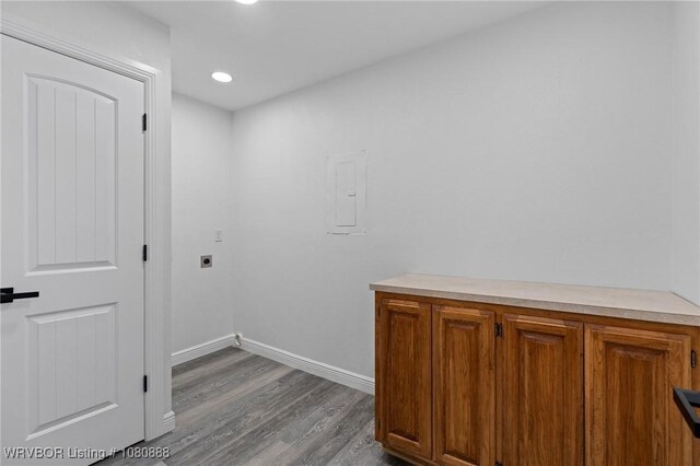 clothes washing area featuring electric dryer hookup, dark wood-type flooring, baseboards, recessed lighting, and electric panel