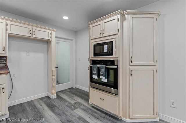 kitchen featuring oven, black microwave, dark wood-style floors, baseboards, and recessed lighting