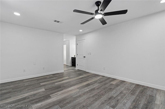 spare room with dark wood-style floors, recessed lighting, a ceiling fan, and baseboards