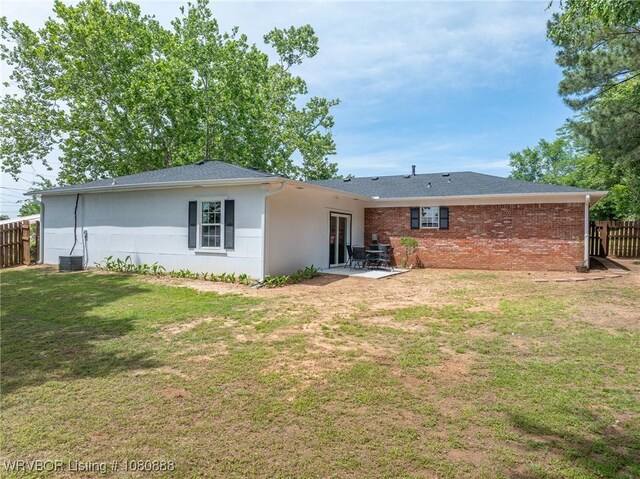 rear view of house with a patio area and central AC unit