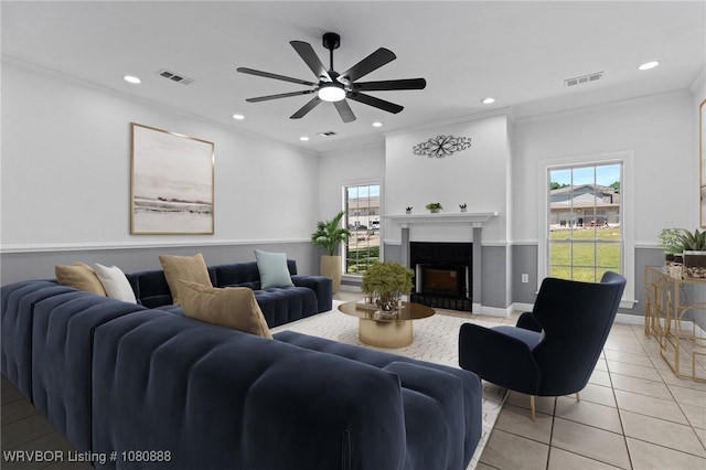 living room featuring light tile patterned flooring, plenty of natural light, a ceiling fan, recessed lighting, and a fireplace