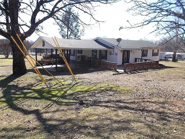 rear view of house featuring a deck